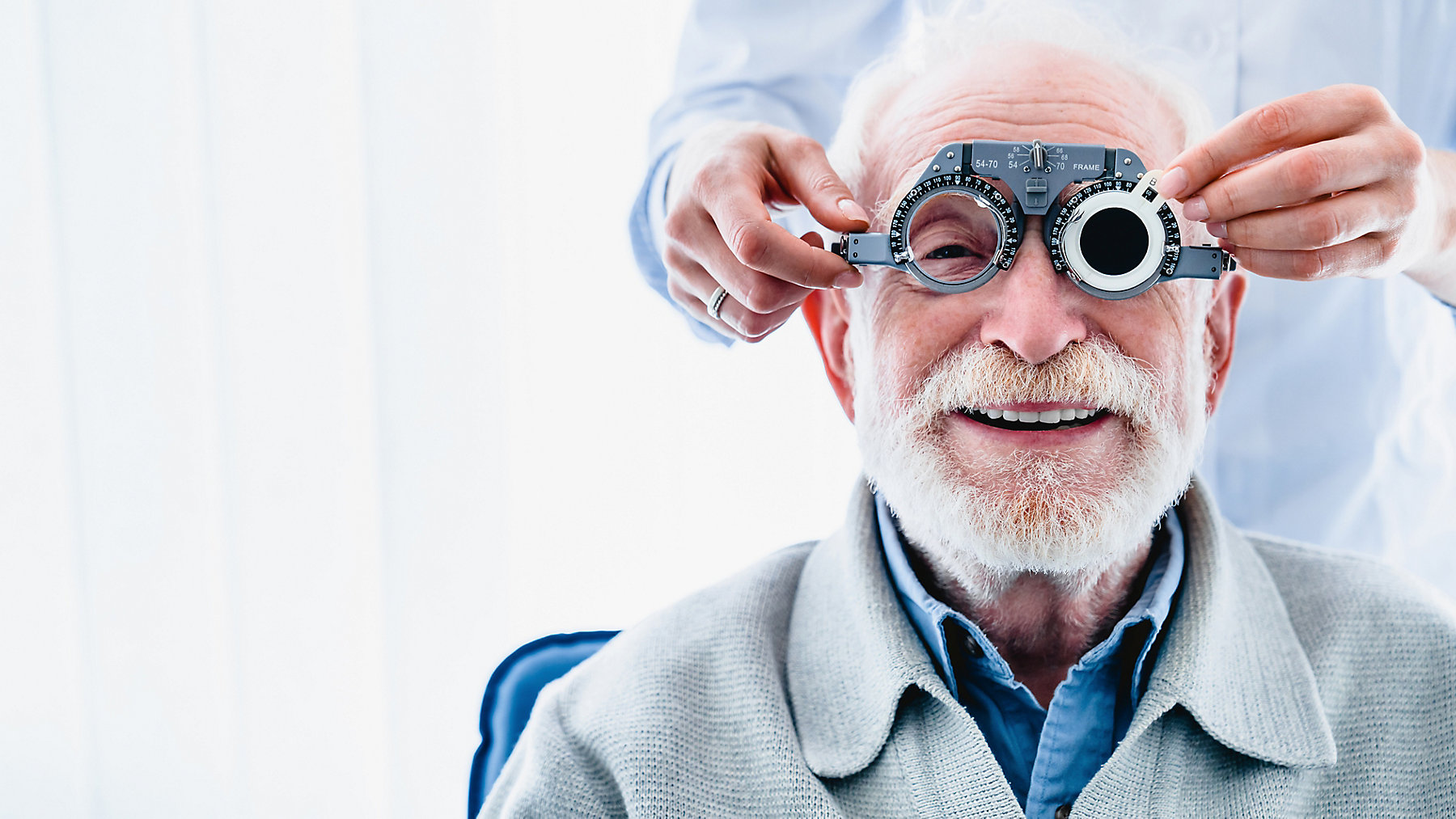 Portrait of a happy mature male patient undergoing vision check with special ophthalmic glasses; Shutterstock ID 1833489469; purchase_order: -; job: -; client: -