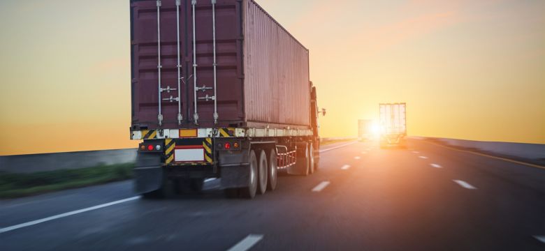 trucks driving into the sunset