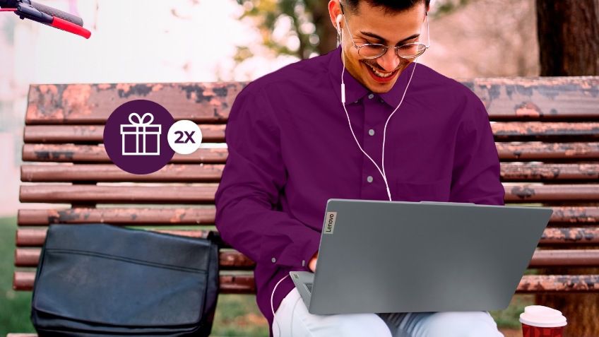 Un hombre sentado en el banco de un parque, con una laptop Lenovo ThinkPad Serie T sobre sus piernas y un maletín apoyado a su izquierda.
