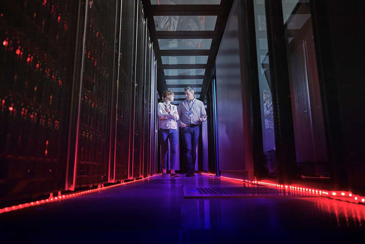 Two colleagues in a server room. 