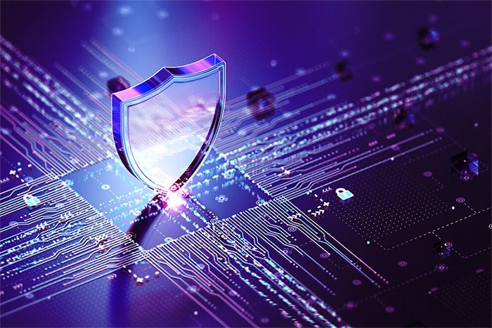 A clear shield on top of a computer chip with purplish light around it.