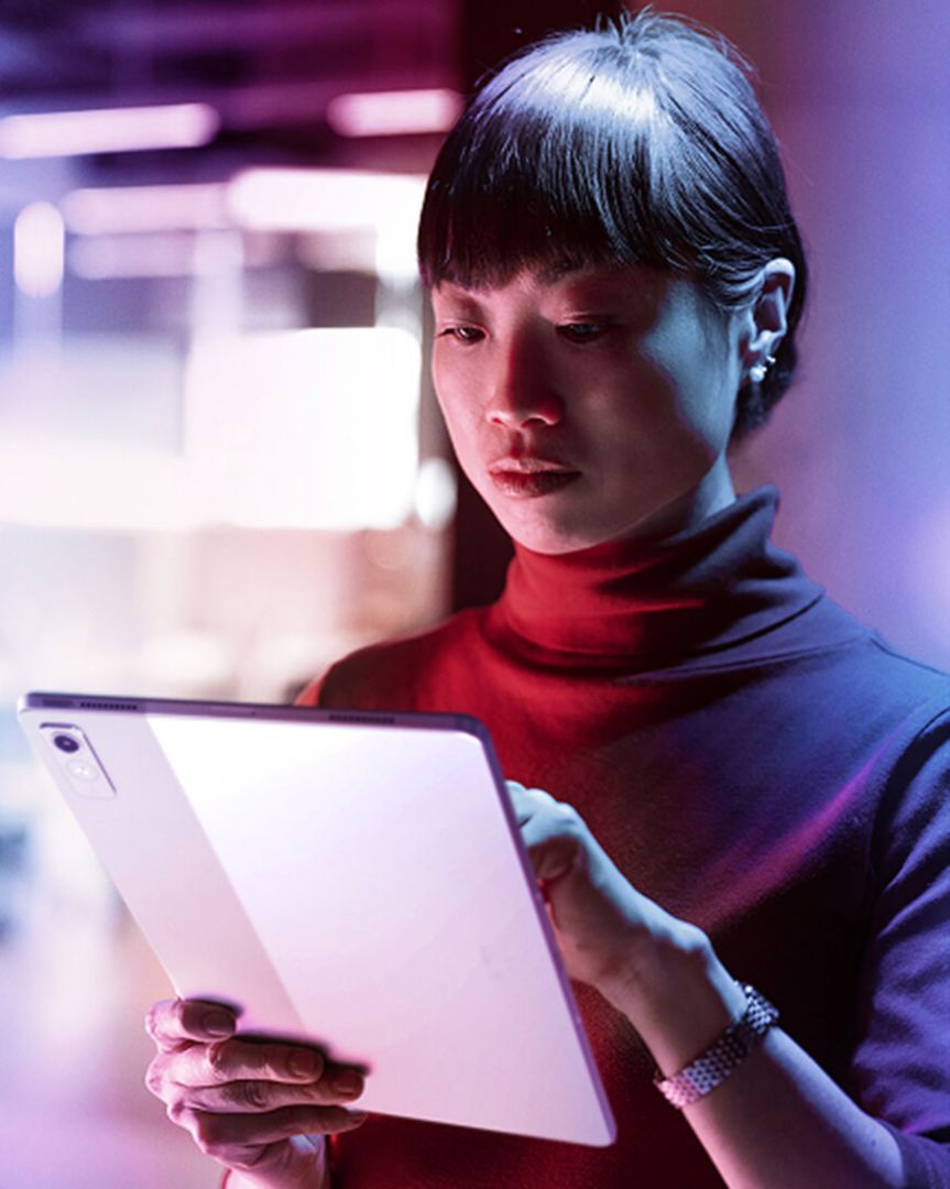 A woman looking at a tablet.