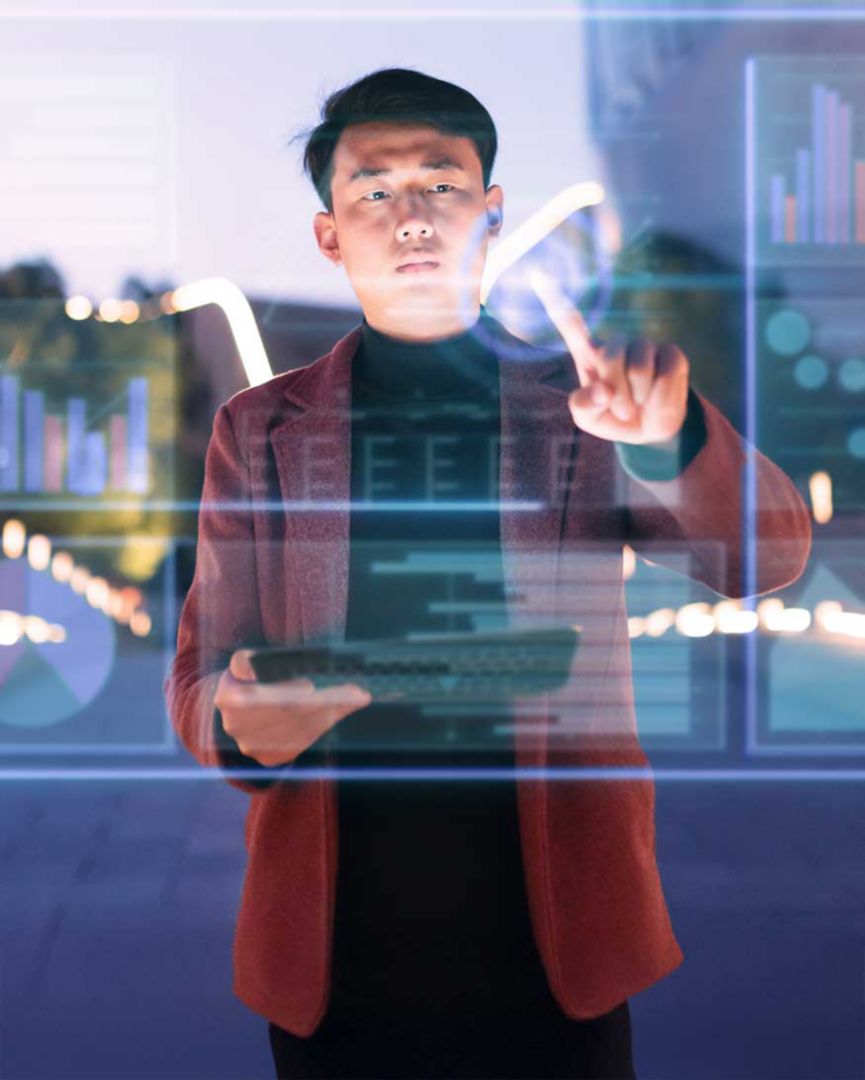 A man holding a tablet and using his finger to write on glass.