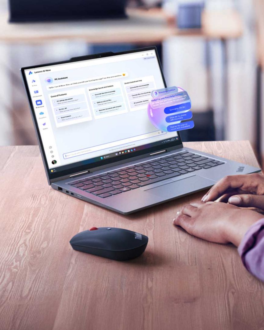 Hands using a laptop with an inset of an AI digital assistant helping.