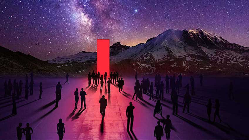 Silhouettes of people walking toward the red Lenovo portal with a mountain in the background.