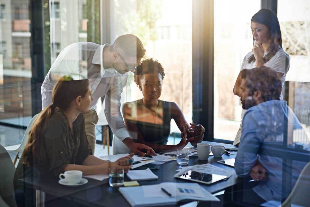 Five colleagues working at a table.