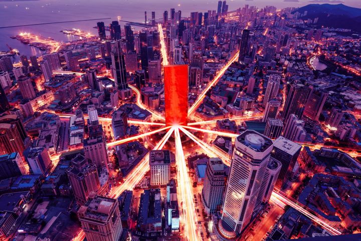 The red Lenovo portal in the middle of a city circle, with light streaming down the roads.