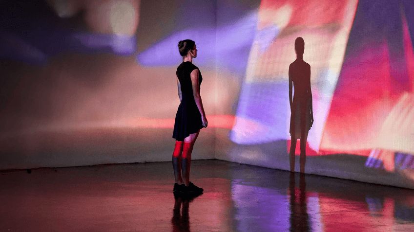 People interact with a projected digital interface.