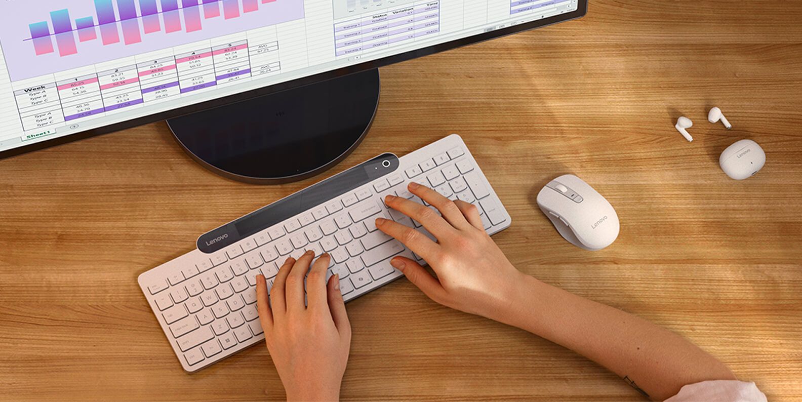 Hands typing on a keyboard, with a mouse next to them.