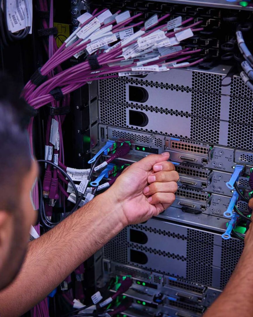 Man performing maintenance on server.