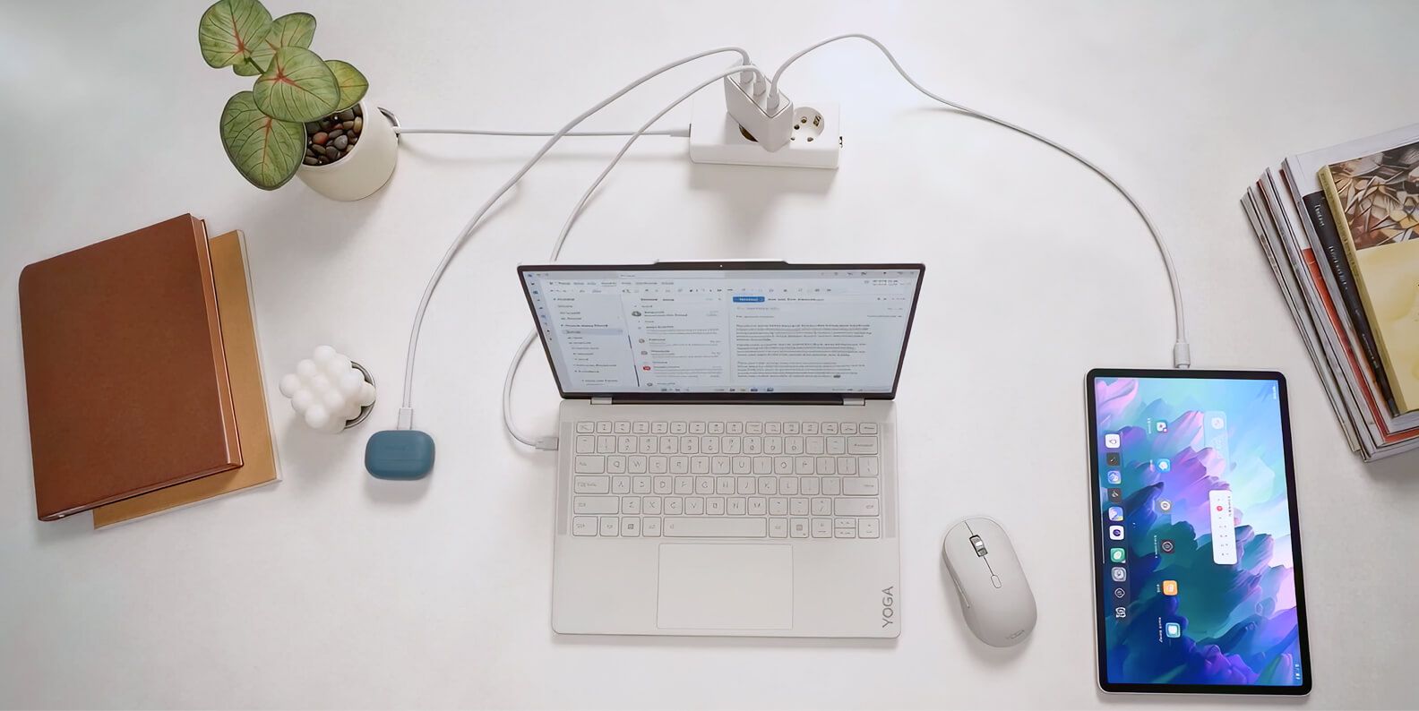 A power bank charging headphones, a laptop, and a tablet.