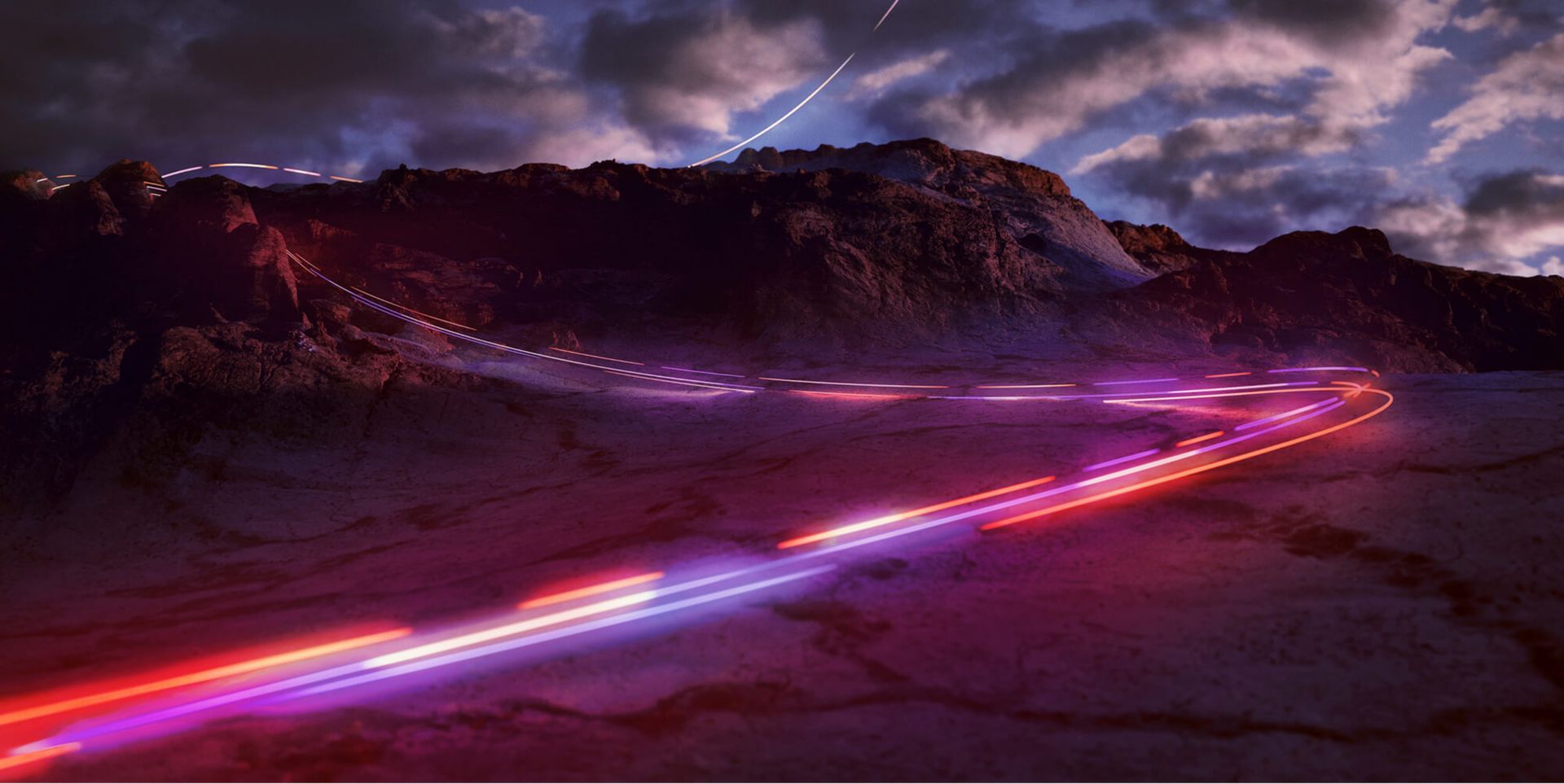 A time lapses of red and purple lights driving on a windy road at dusk.