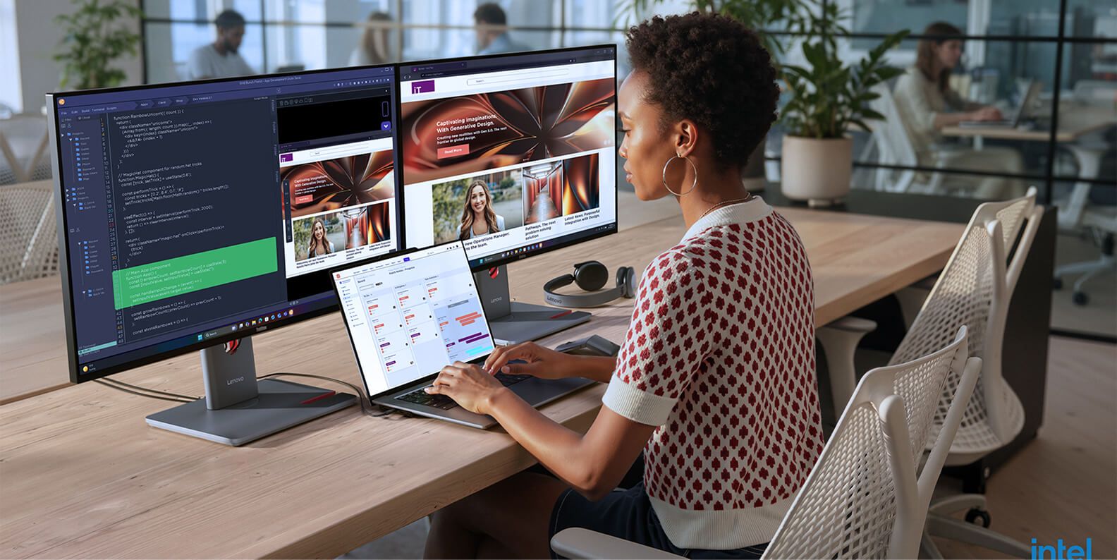 A woman using an AI PC laptop and two monitors.