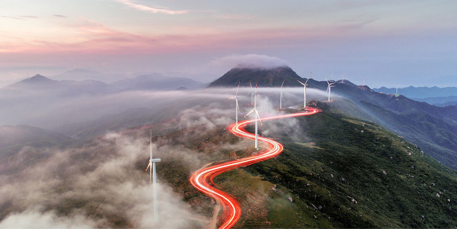  A red light weaving between turbines on the hilltops.