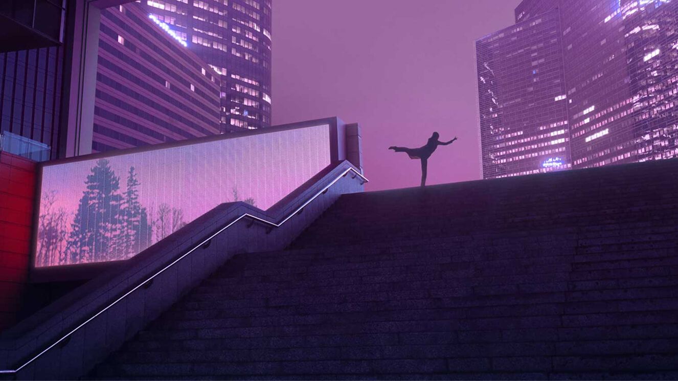 A silhouette of a person doing an arabesque at the top of a staircase with city buildings and the night sky behind them. 