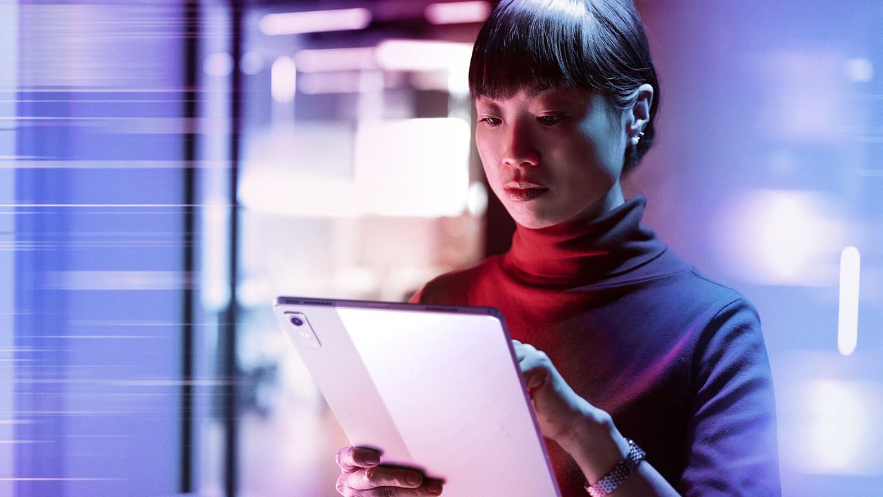 A woman looking at a tablet.