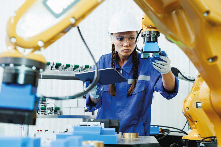A manufacturing worker checking a machine