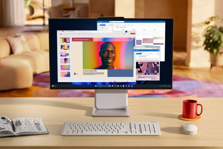 Front view of the Lenovo IdeaCentre AIO (27”) in a home office setting with multiple windows open on the display.