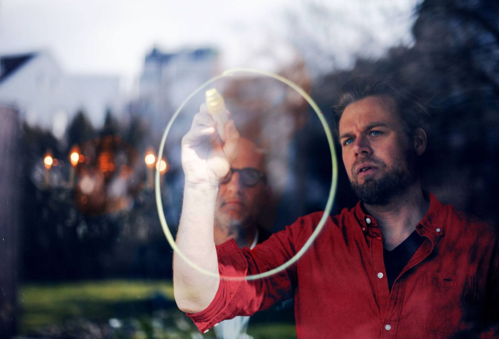 A Lenovo employee drawing on a glass wall. 