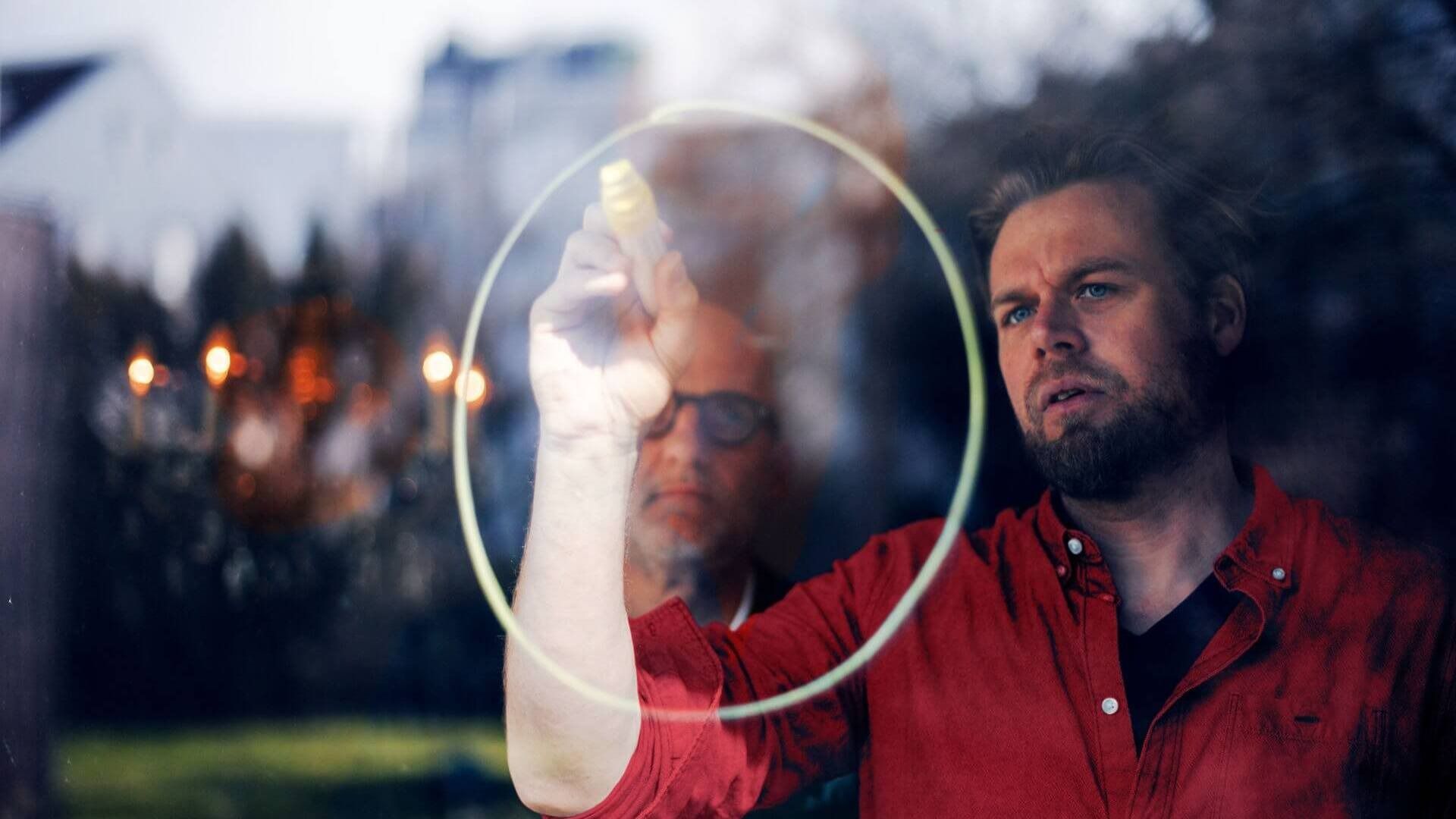 A Lenovo employee drawing on a glass wall. 