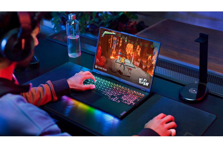 A young man playing a game on his laptop