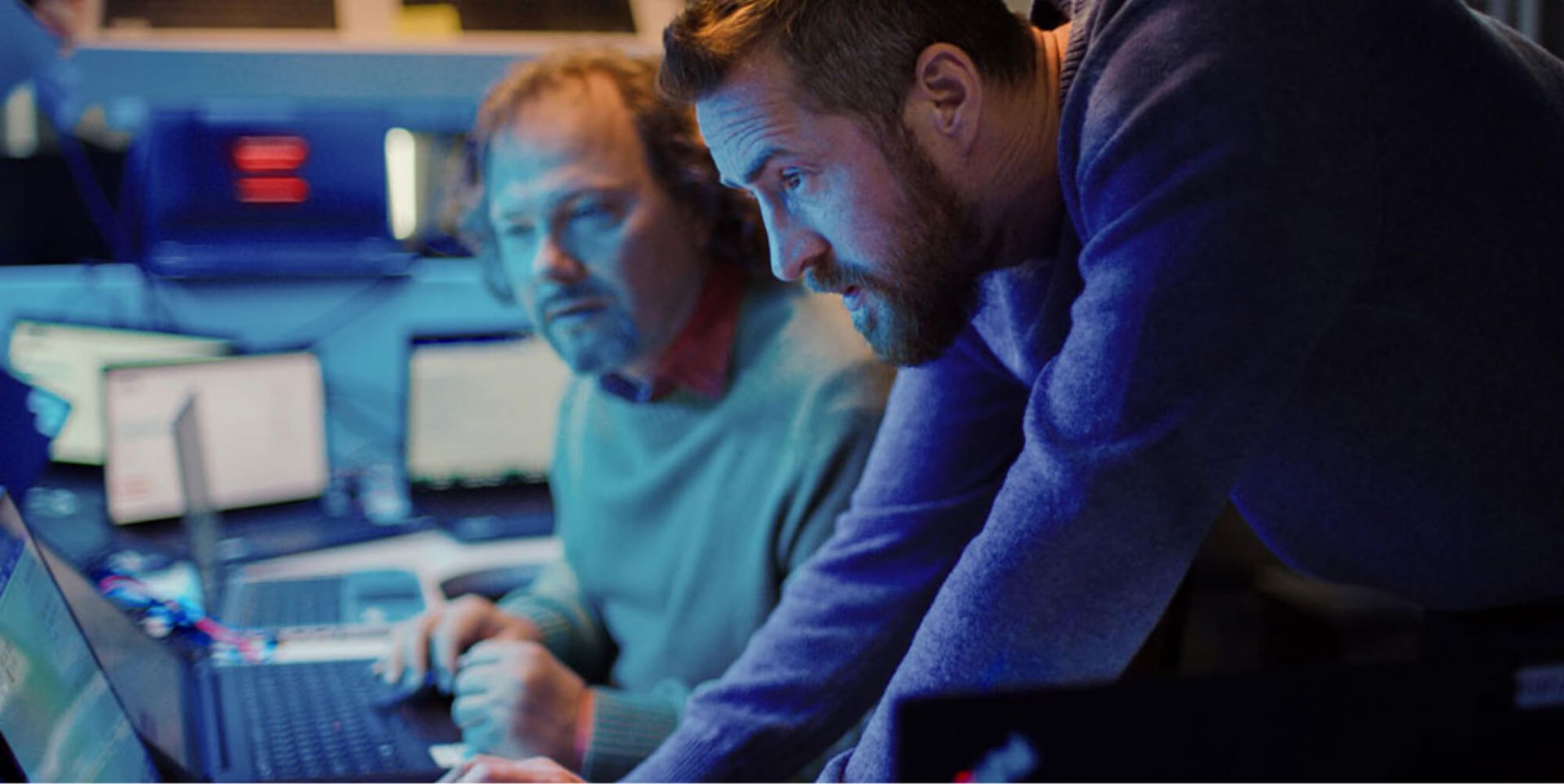 Two colleagues looking at a computer screen.