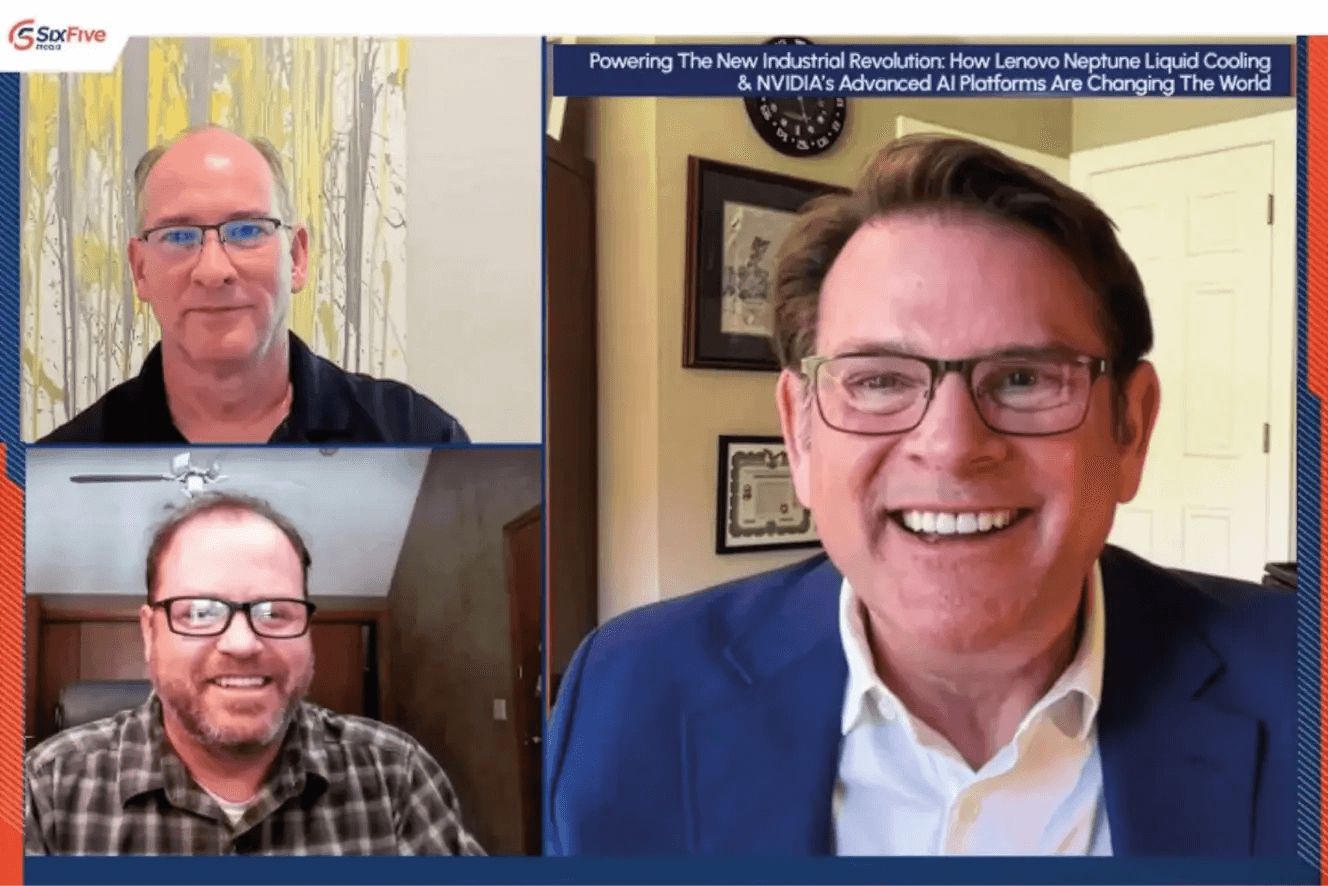 Three people meeting in a web hosted meeting smiling and talking