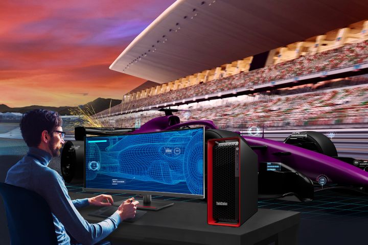 Engineer analyzing race car performance data beside a Lenovo ThinkStation workstation