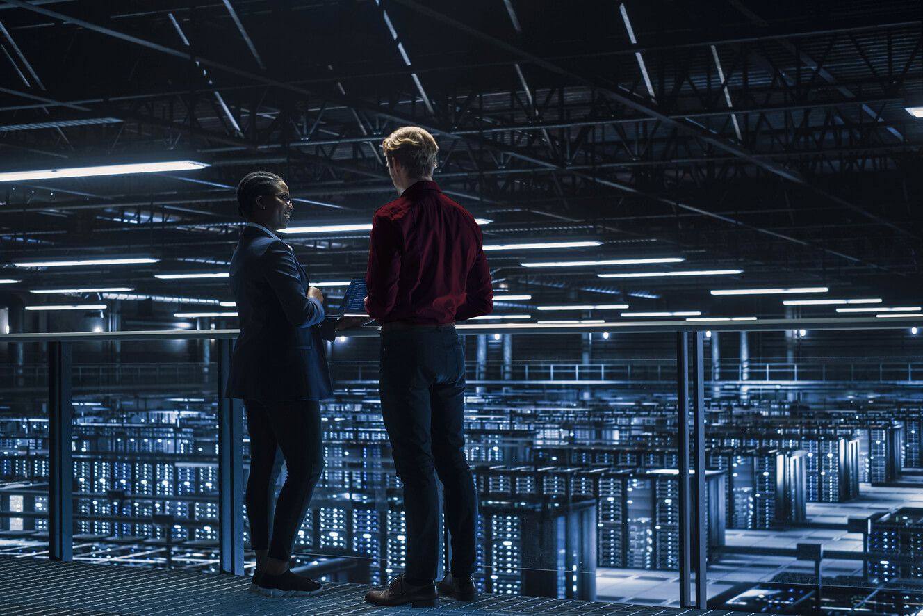 Two men overlooking a server room. 