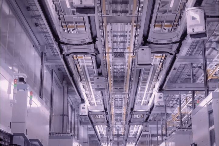 Automated overhead transport system in a high-tech manufacturing facility.