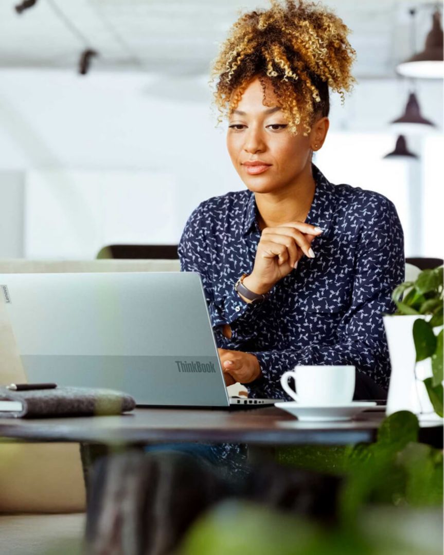 A woman in an office using a laptop.