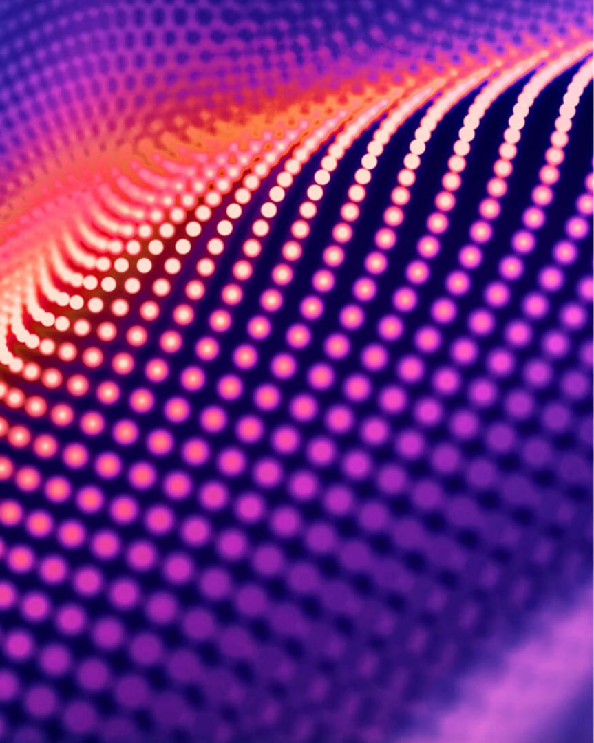 An abstract image of gold and purple dots of light.
