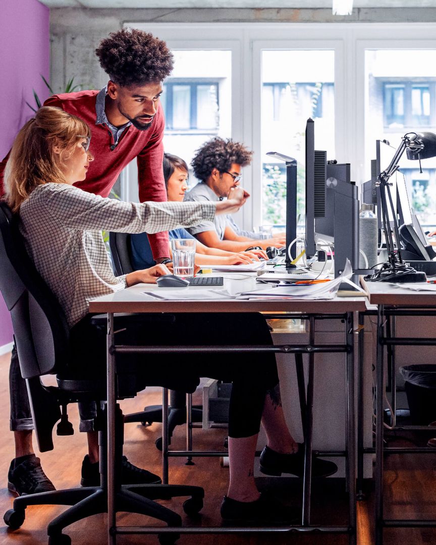 A row of employees working on computers.
