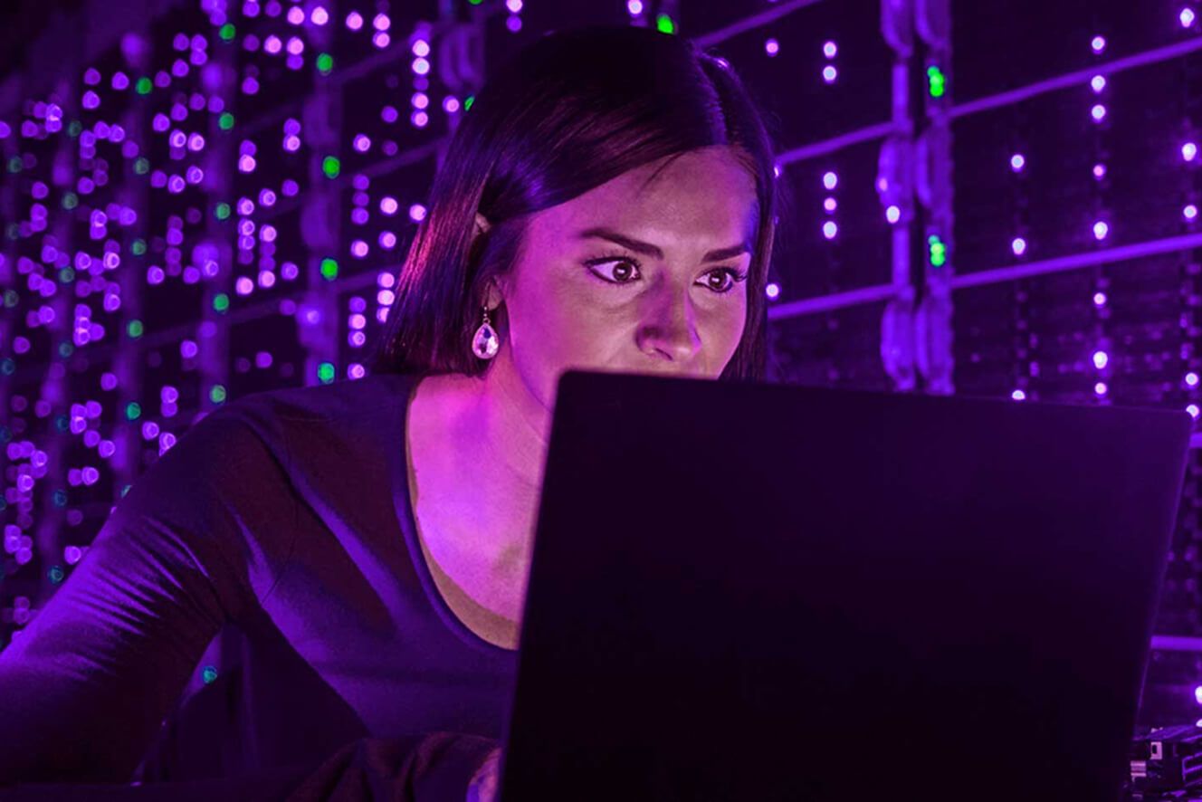 A woman staring at her laptop.