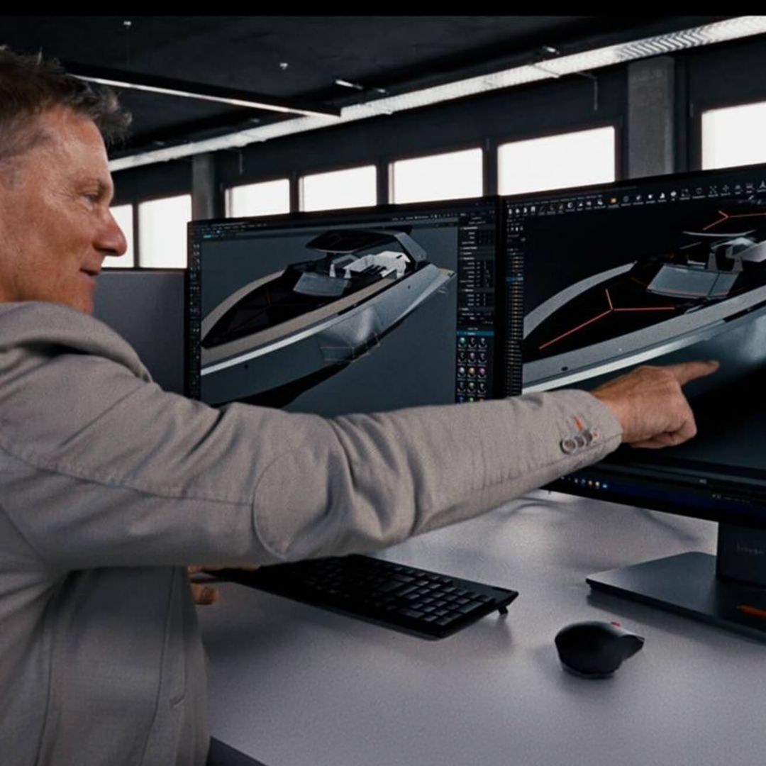 A yacht designer pointing at his monitor.