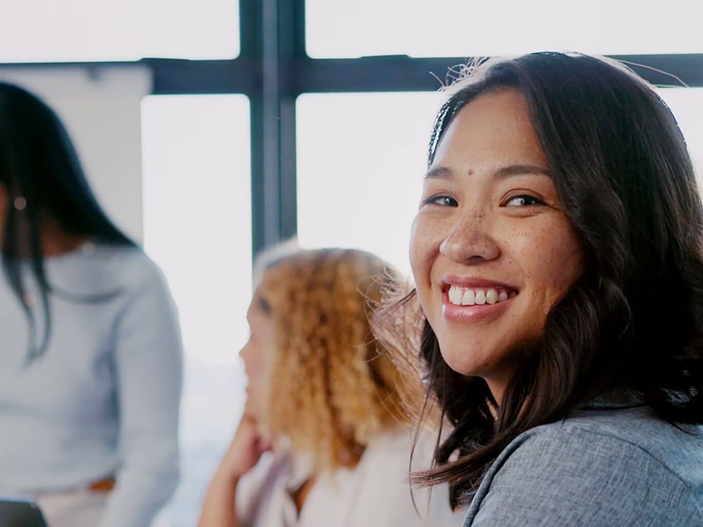 Two female employees smiling. 