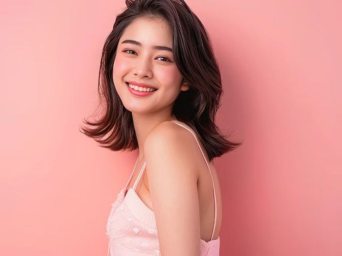 A makeup model smiling.