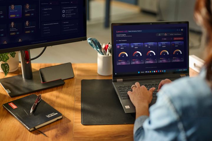 A woman typing on a laptop at her desk.