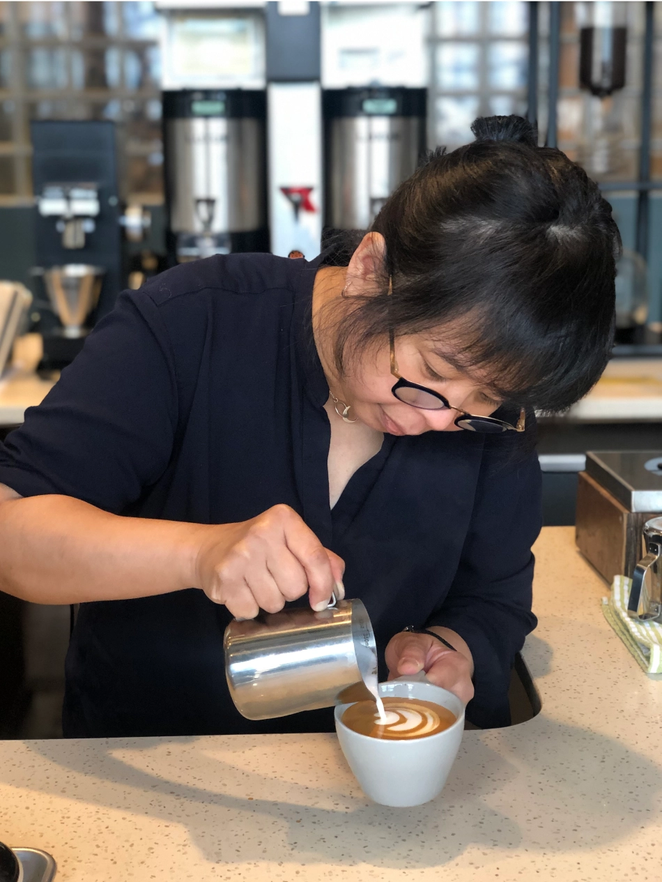 founder picking up spoon from bowl while holding coffee cup