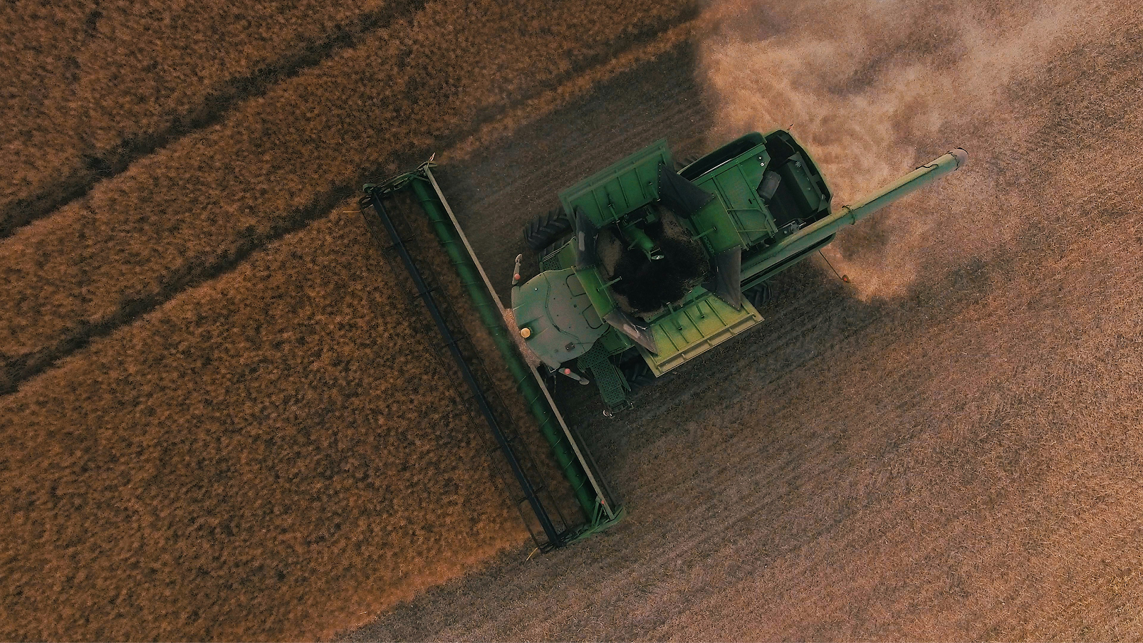john deere tractor driving in a field