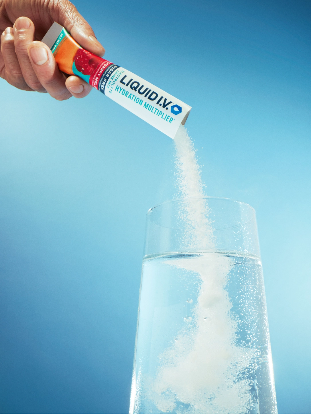 Liquid IV poured into a glass of water