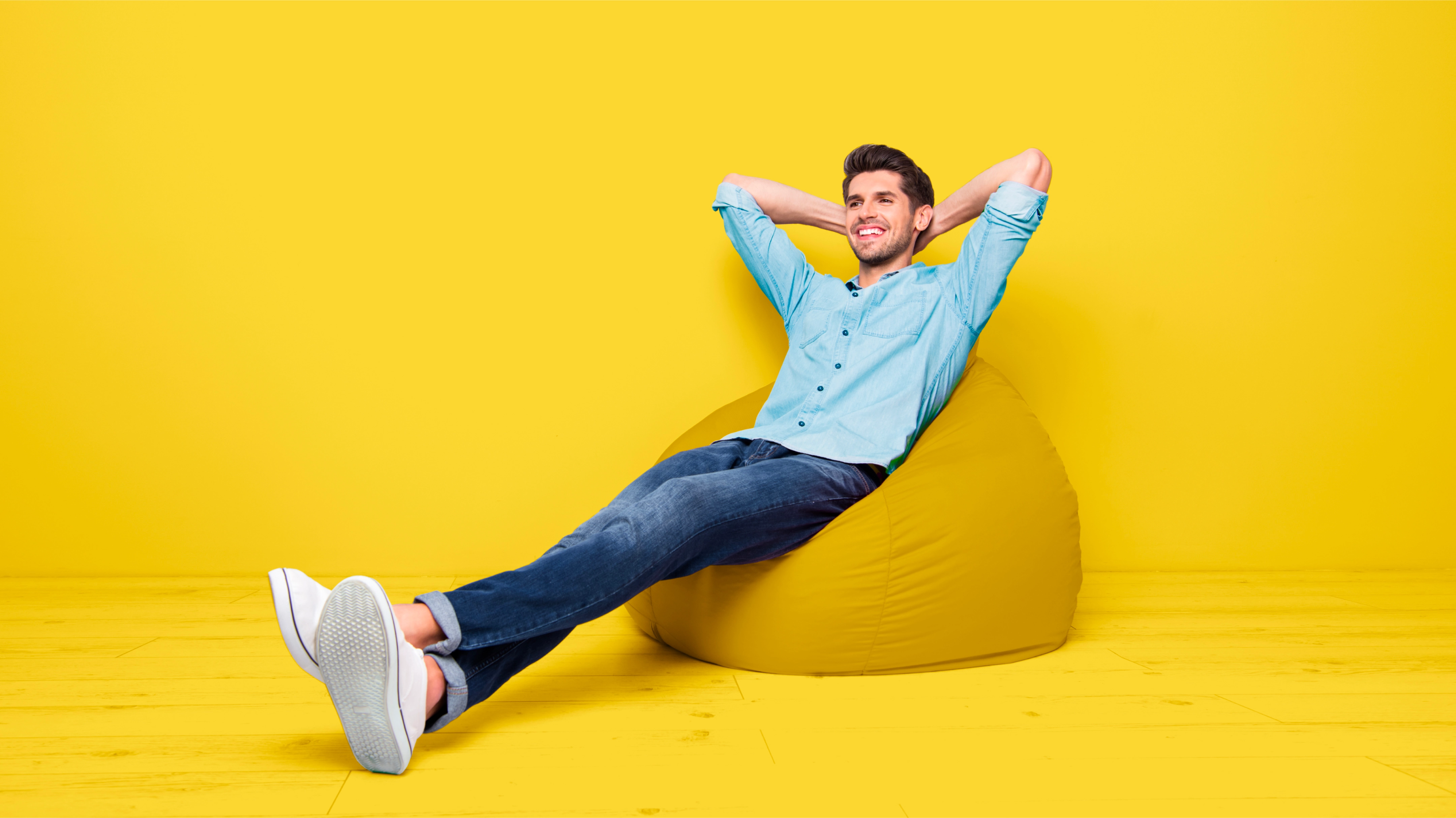 paze ad person sitting on yellow beanbag