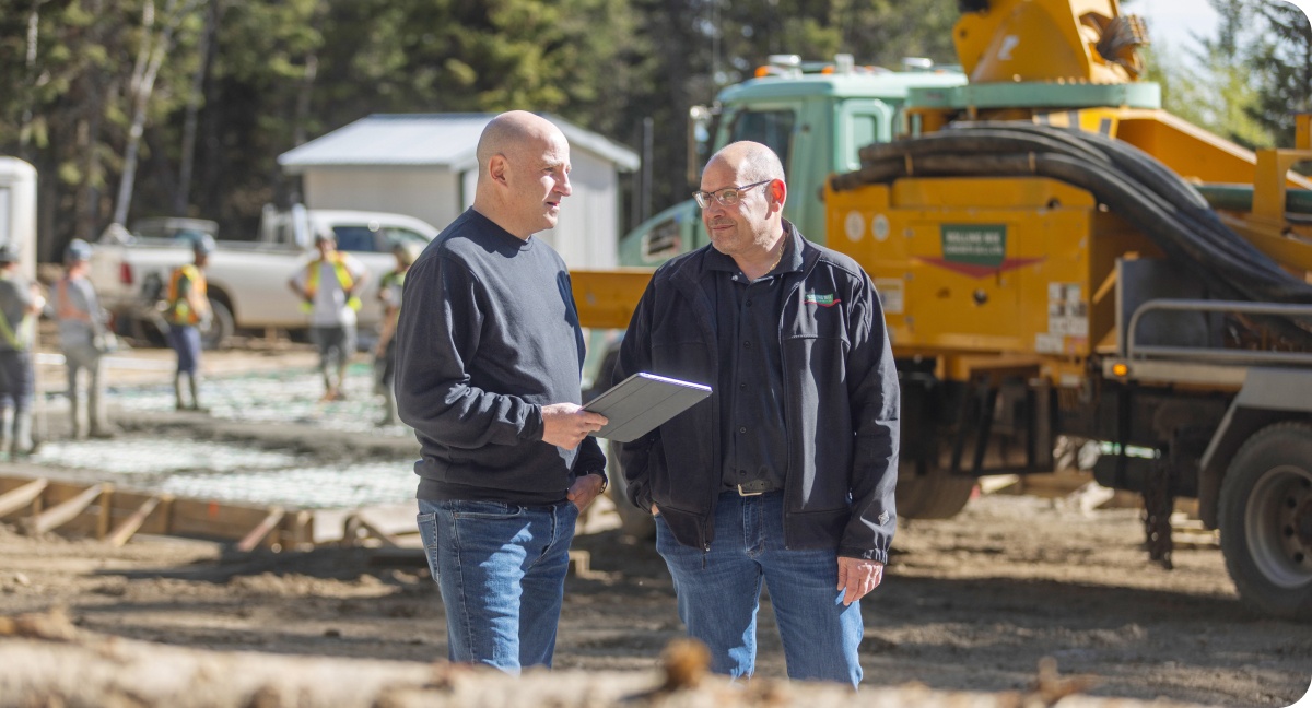Photo of two equipment dealers exploring their financing options with National Bank