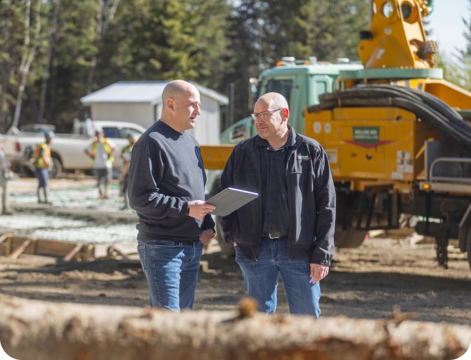 Photo of two equipment dealers exploring their financing options with National Bank