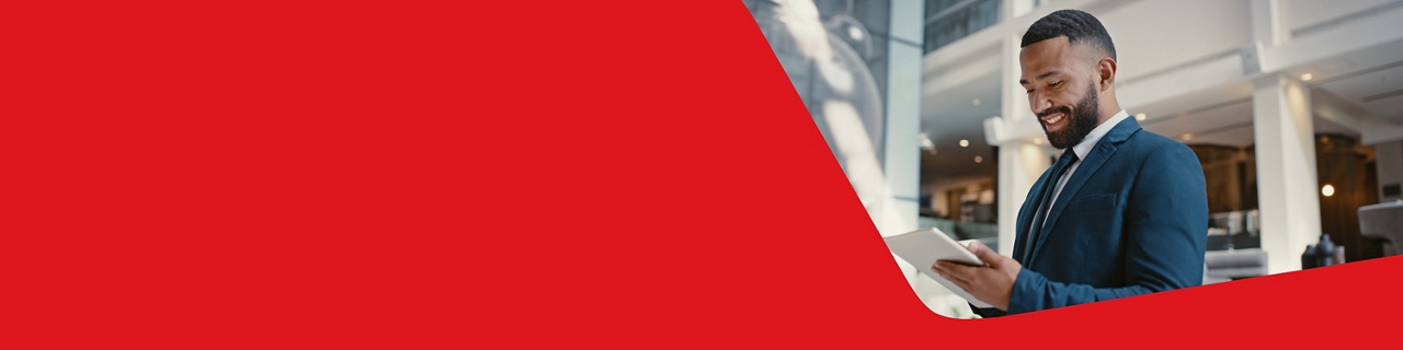 Photo of a businessperson choosing the National Bank Premium Business Package on their tablet in an office building