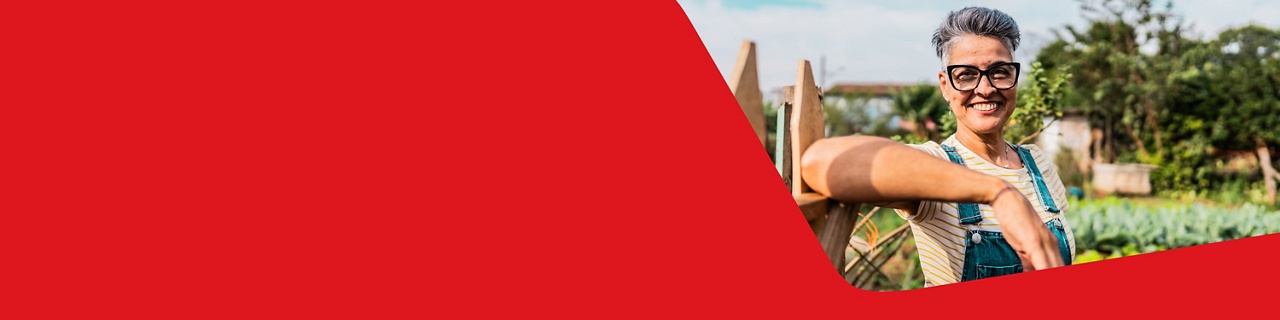 Photo of a farmer in her garden happy to have chosen National Bank’s solutions for agribusinesses 