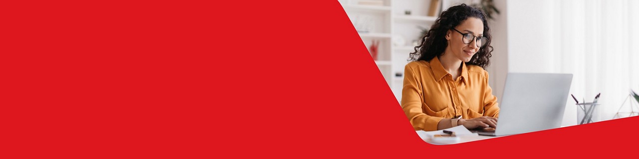 Photo of a woman on her computer getting information regarding currency hedging 