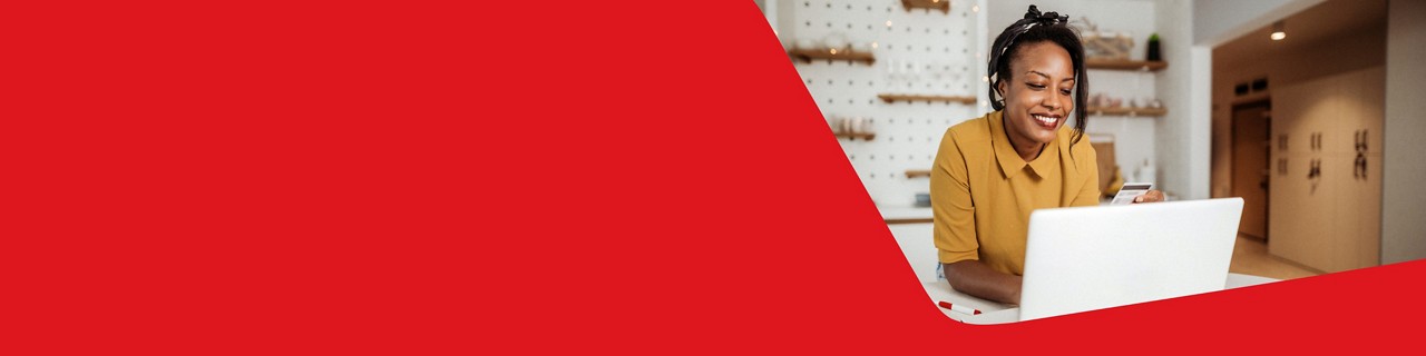 Photo of a woman looking at National Bank Mastercard credit cards on her computer 