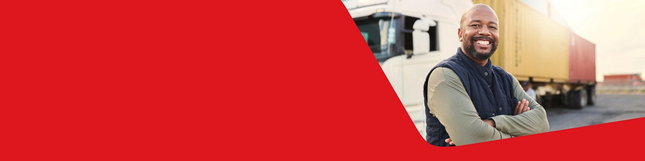 Photo of a smiling businessowner in front of his truck that is a part of his cross-border operations 