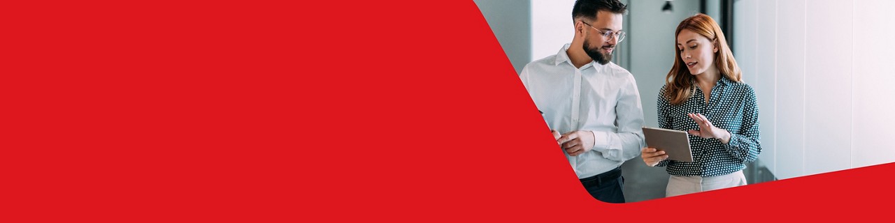 Photo of two entrepreneurs in an office looking at their tablets and discussing their USD account 